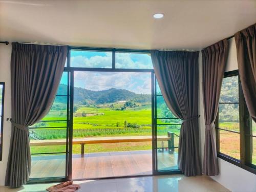 a room with a large window with a view at สวนไร่รุ่งอรุณ Suan Rai Rungarun in Ban Na Pa Paek
