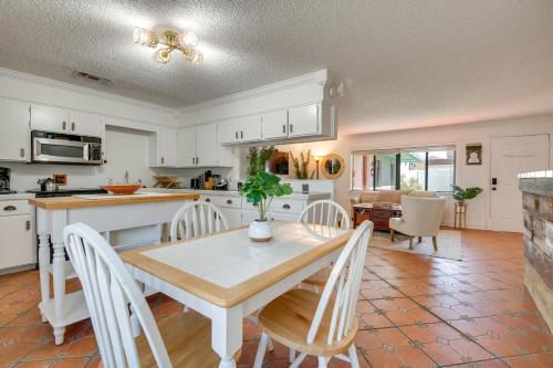 a kitchen and dining room with a table and chairs at 2 Blocks to Beach! Cape Canaveral Apt with Patio in Cape Canaveral