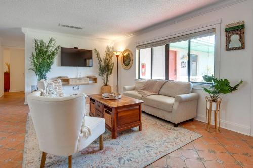 a living room with a couch and a table at 2 Blocks to Beach! Cape Canaveral Apt with Patio in Cape Canaveral