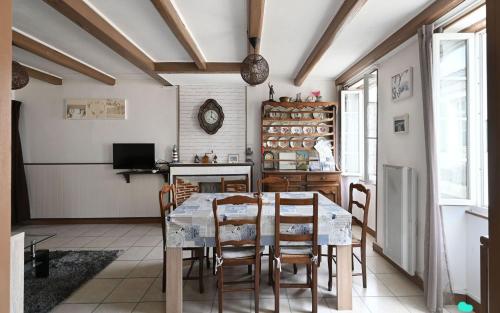 a dining room with a table and chairs at Villa des Ormeaux in Les Moulins de la Boire