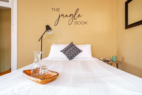 a bedroom with a white bed with a vase and a book at Prime Location Top Rated Free Parking Clean in Columbus