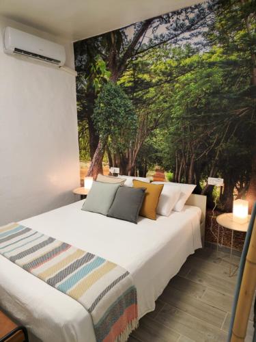 a bed in a room with a mural on the wall at La Herbolera Vv Apartamento in Teror