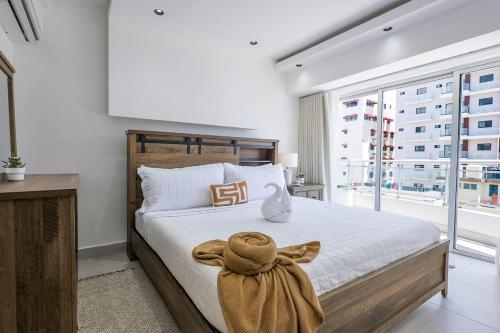 a bedroom with a large bed with a large window at Spacious, 3BD City Center Apt in La Julia