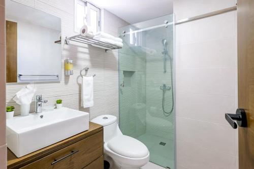 a bathroom with a sink and a glass shower at Spacious, 3BD City Center Apt in La Julia