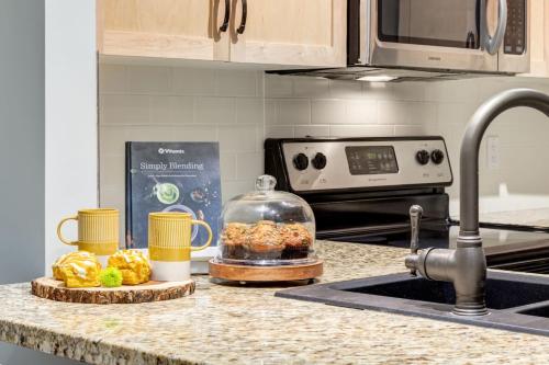 a kitchen counter with a sink and a kitchen counter top with a counter top at Lovely 2BR Canmore Condo w Heated Pool and Hot Tub in Canmore