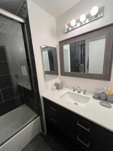 a bathroom with a sink and a mirror and a shower at Charming room in artist studio and Gallery in Santa Clarita
