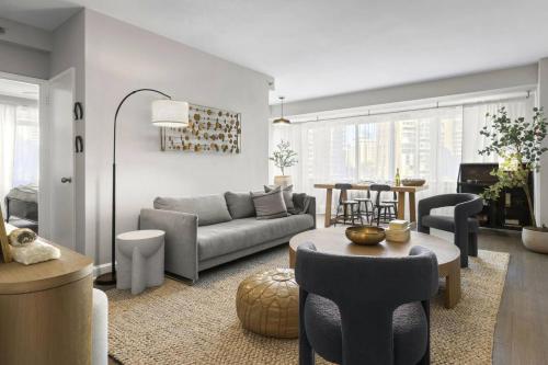 a living room with a couch and a table at The Lexington - Serene Apartment, 5 min to DC with Free Parking and Metro in Arlington