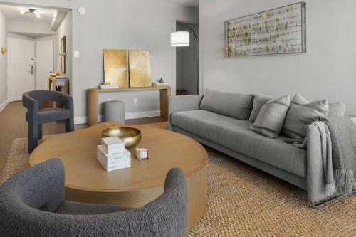 a living room with a couch and a table at The Lexington - Serene Apartment, 5 min to DC with Free Parking and Metro in Arlington