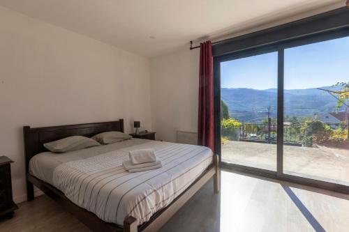 a bedroom with a bed and a large window at Casa de Clarisse in Ermelo