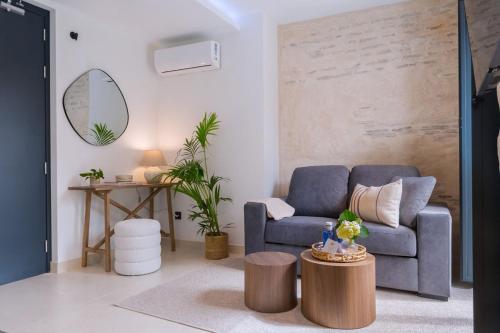 a living room with a blue couch and a table at Luxury Apartment overlooking Casa Pilatos in Seville