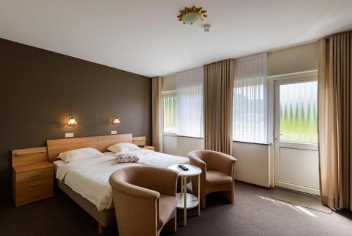 Postel nebo postele na pokoji v ubytování Hotel Bemelmans