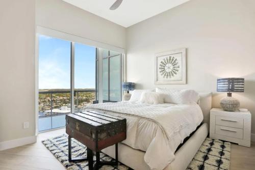 a bedroom with a large bed and a large window at Ultra-luxury Coastal Retreat in Pompano Beach