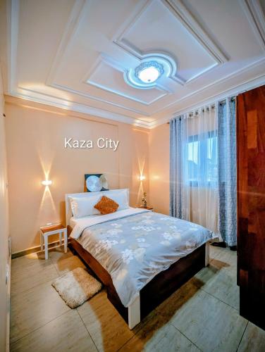 a bedroom with a king sized bed in a room at KAZA City in Bafoussam