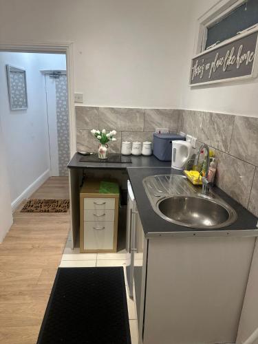 a kitchen with a sink and a counter top at Comfy stay, Stockwell SW9 in London