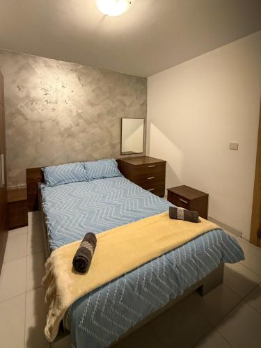 a bedroom with a bed and two night stands at Spacious Peaceful Apartment - Tarxien in Tarxien
