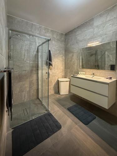 a bathroom with a tub and a sink and a shower at Spacious Peaceful Apartment - Tarxien in Tarxien
