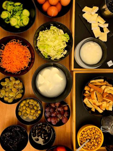 a wooden table with bowls of different types of food at Alle Porte in Riva del Garda