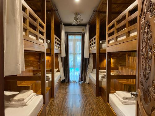a room with a bunch of bunk beds at Bloom Cafe & Hostel in Ko Lipe