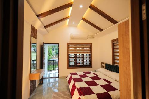 a bedroom with a bed and a balcony at Wayanadan Huts Homestay in Sultan Bathery