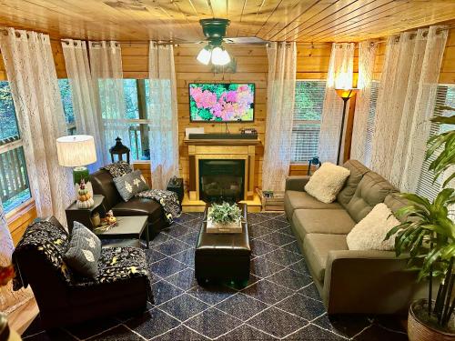 a living room with a couch and a fireplace at Cozy Cabin in Red River Gorge in Rogers
