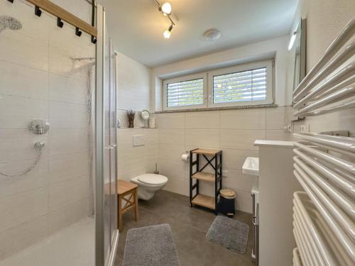 a bathroom with a toilet and a sink and a shower at Hasn Res in Kleinwinklarn