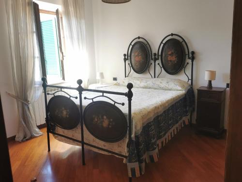 a bedroom with a bed with a black frame at La Terrazza di Maria in Pienza