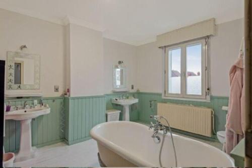 a bathroom with two sinks and a bath tub at Nyumbani Stays in Boom