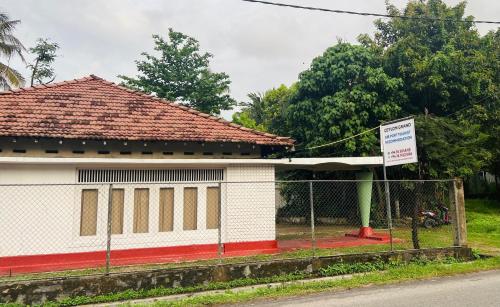 a building with a fence in front of it at Ceylon Grand Airport Tourist Accommodation in Katunayake