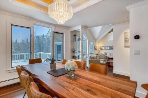 a dining room and living room with a table and chairs at Edson Hill Estate in Stowe