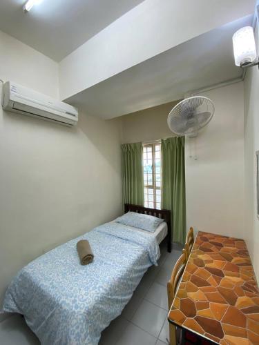 a bedroom with two twin beds and a fan at Budget Friendly 3Bedroom Walkable to USM in Gelugor