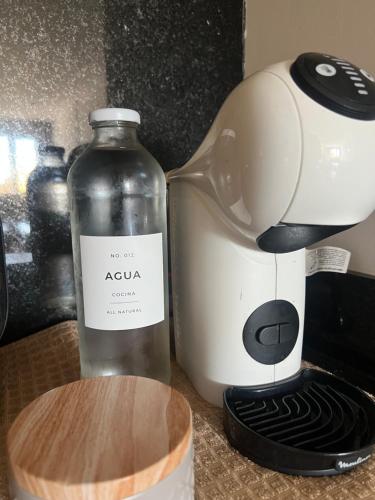 a bottle of wine next to a coffee maker at CONDOMINIOS DE BAHIA GRANDE NORDELTA!! Tigre in Tigre