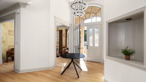 a hallway with a table and a chandelier at Expansive Lakehouse W Stunning Pool & Views in The Hills