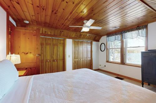 Un dormitorio con una cama y un techo de madera. en Four Seasons Lakehouse, en Franklin