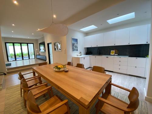 a kitchen and dining room with a wooden table and chairs at Palazzo 126 Luxury 5BR Pool Villa in Patong in Patong Beach
