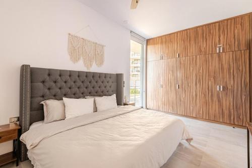 a bedroom with a large bed and a large window at Luxury apartment overlooking the Arch in Cabo San Lucas