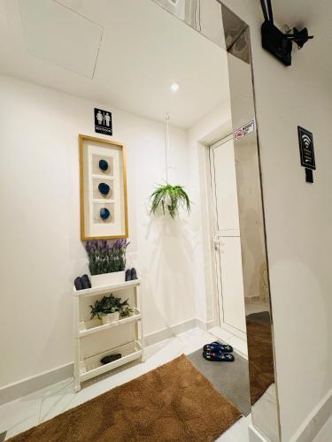 a bathroom with a shower and a mirror at Vogue Inn Abu Dhabi in Abu Dhabi