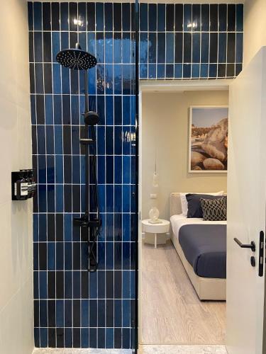 a bedroom with a bed and a blue tiled wall at Palazzo 126 Luxury 5BR Pool Villa in Patong in Patong Beach