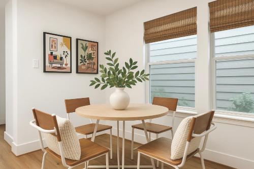 a dining room with a table and chairs and a vase with a plant at Stylish Stays in Historic Fourth Ward in Houston