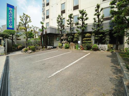 an empty parking lot in front of a building at Hotel Cerezo in Tokyo
