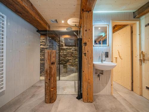 a bathroom with a glass shower and a sink at Raneburg 4 Stallhaus in Matrei in Osttirol