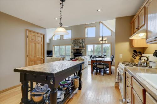 a kitchen with a table and a dining room at Four Seasons Chalet in Waterbury Center