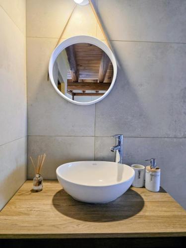a bathroom with a bowl sink and a mirror at Cabañas Altos del Nopal in Ciudad Lujan de Cuyo