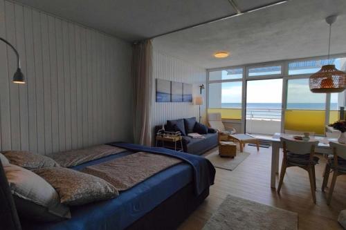 une chambre avec un lit, un canapé et une table dans l'établissement Inselblume 59 - Moderne Ferienwohnung mit Meerblick, à Burgtiefe auf Fehmarn 