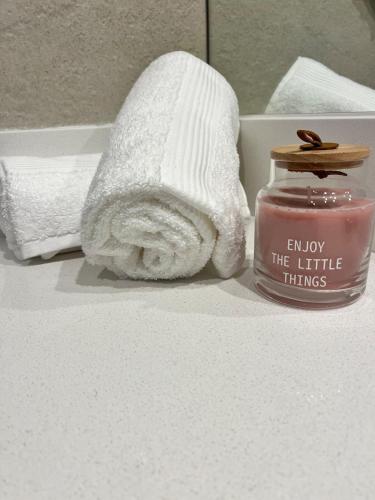a bathroom with a towel and a jar of candle at Link in Montevideo