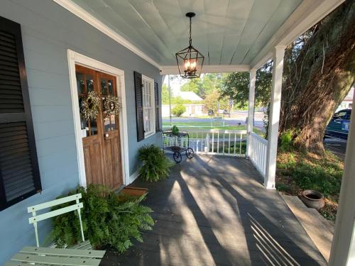 a porch with a bench on a house at Alice by Ravens Keep in Jackson