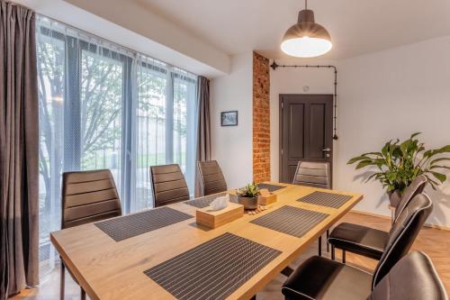 a dining room with a wooden table and chairs at Penzion Malý in Krnov