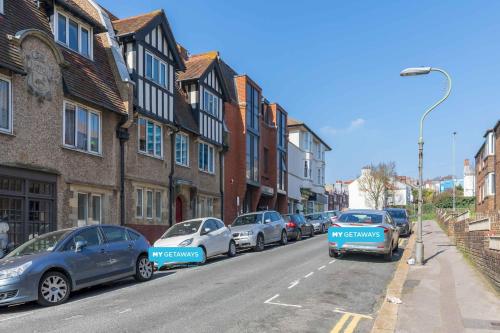 a row of cars parked on the side of a street at Urban Heights By My Getaways in Brighton & Hove