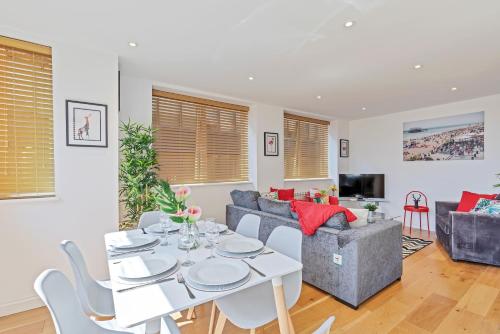 a living room with a table and a couch at Urban Heights By My Getaways in Brighton & Hove