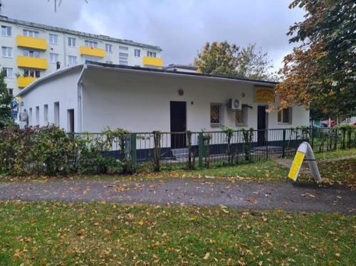 a white building with a fence in front of it at Artishalico tallinn in Tallinn