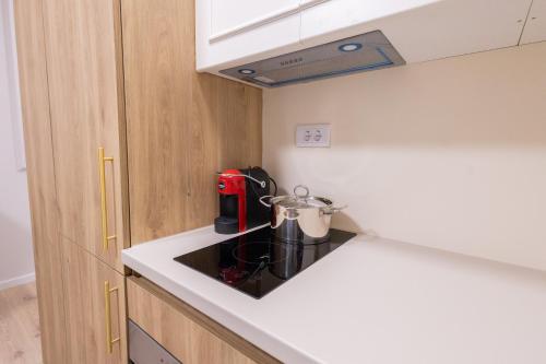 a kitchen with a stove with a tea kettle on it at CENTRAL Aparments in Novi Pazar